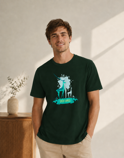 Man wearing a dark green t-shirt with a graphic design of two deer and the text 'Deer Dance' in a bright indoor setting.