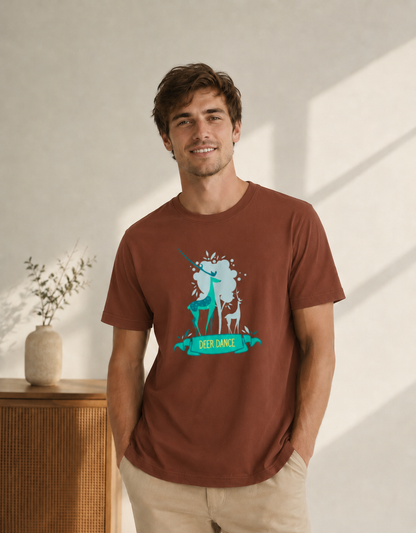 Man wearing a brown t-shirt with a graphic design of a deer and unicorn, standing in a bright room.