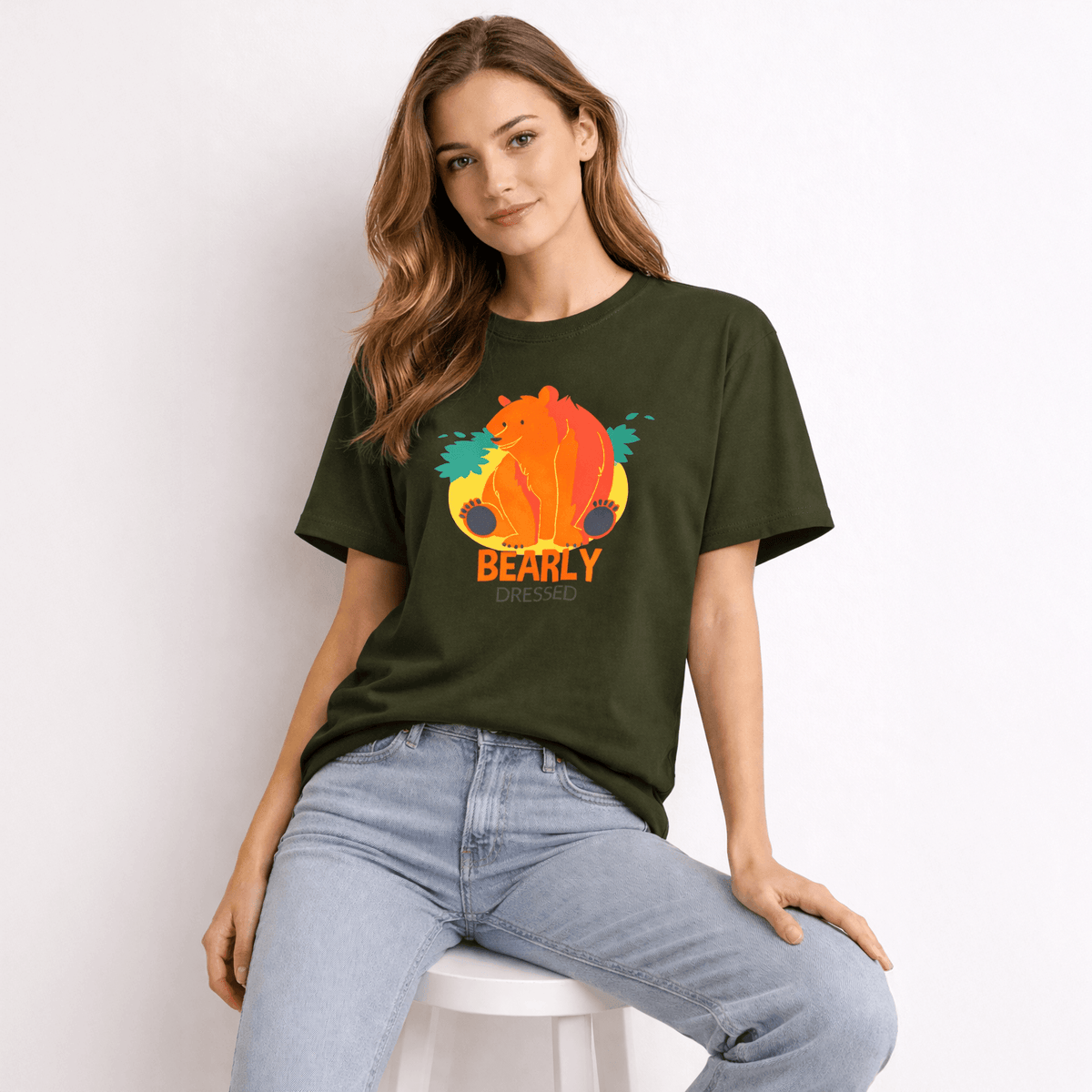 Woman wearing a green t-shirt with a colorful bear graphic and 'BEARLY' text.
