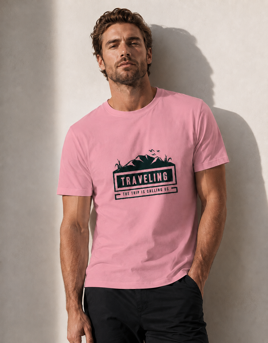 Man wearing a pink t-shirt with a graphic design and text against a plain background
