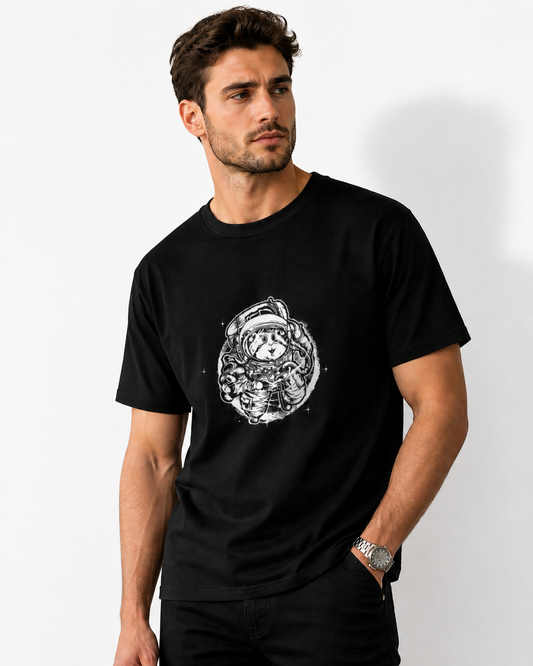 Man wearing a black t-shirt with a white graphic design on a plain background