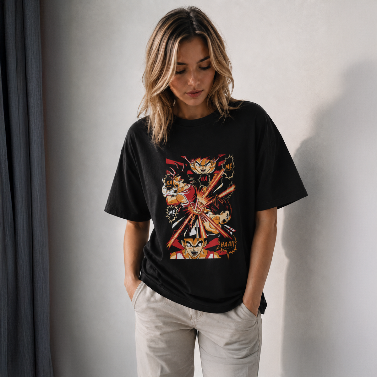 Woman wearing a black t-shirt with a colorful graphic design on a plain background