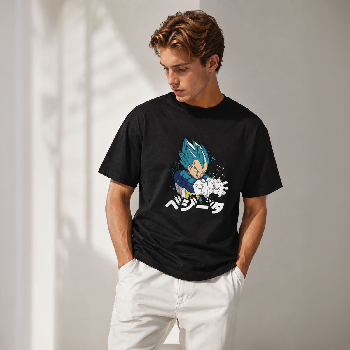 Person wearing a black t-shirt with a graphic design on a plain background