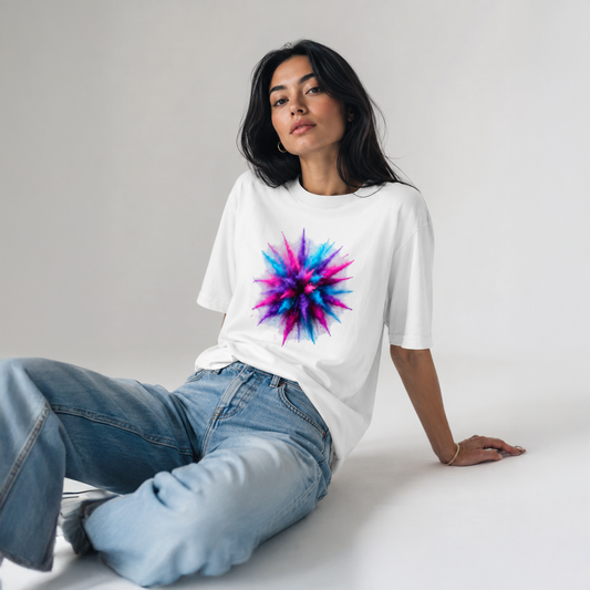 Person wearing a white t-shirt with a colorful starburst design on a plain background